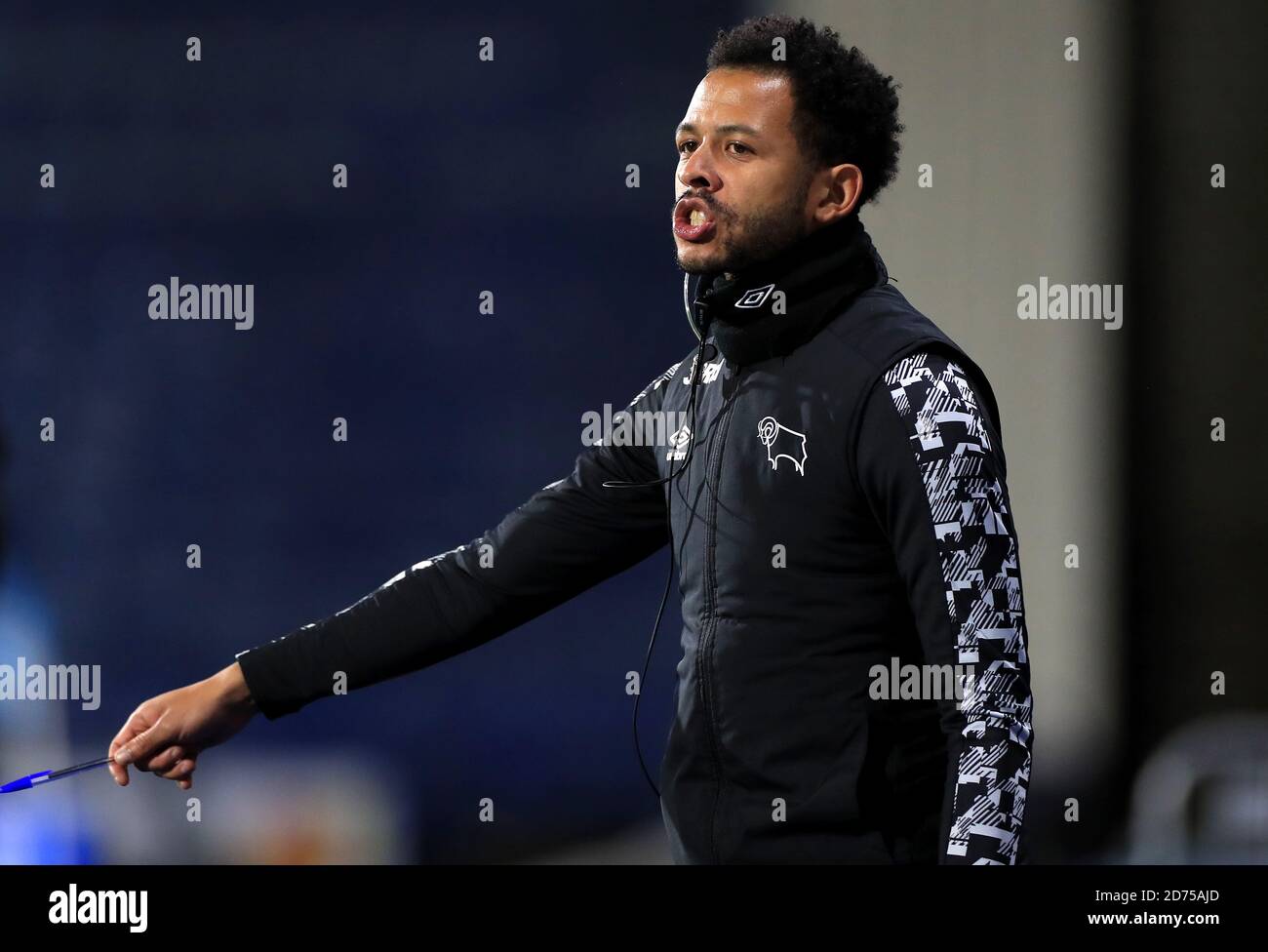 Huddersfield Town performance coach Callum Adams instructs his players during the Sky Bet Championship match at The John Smith's Stadium, Huddersfield. Stock Photo