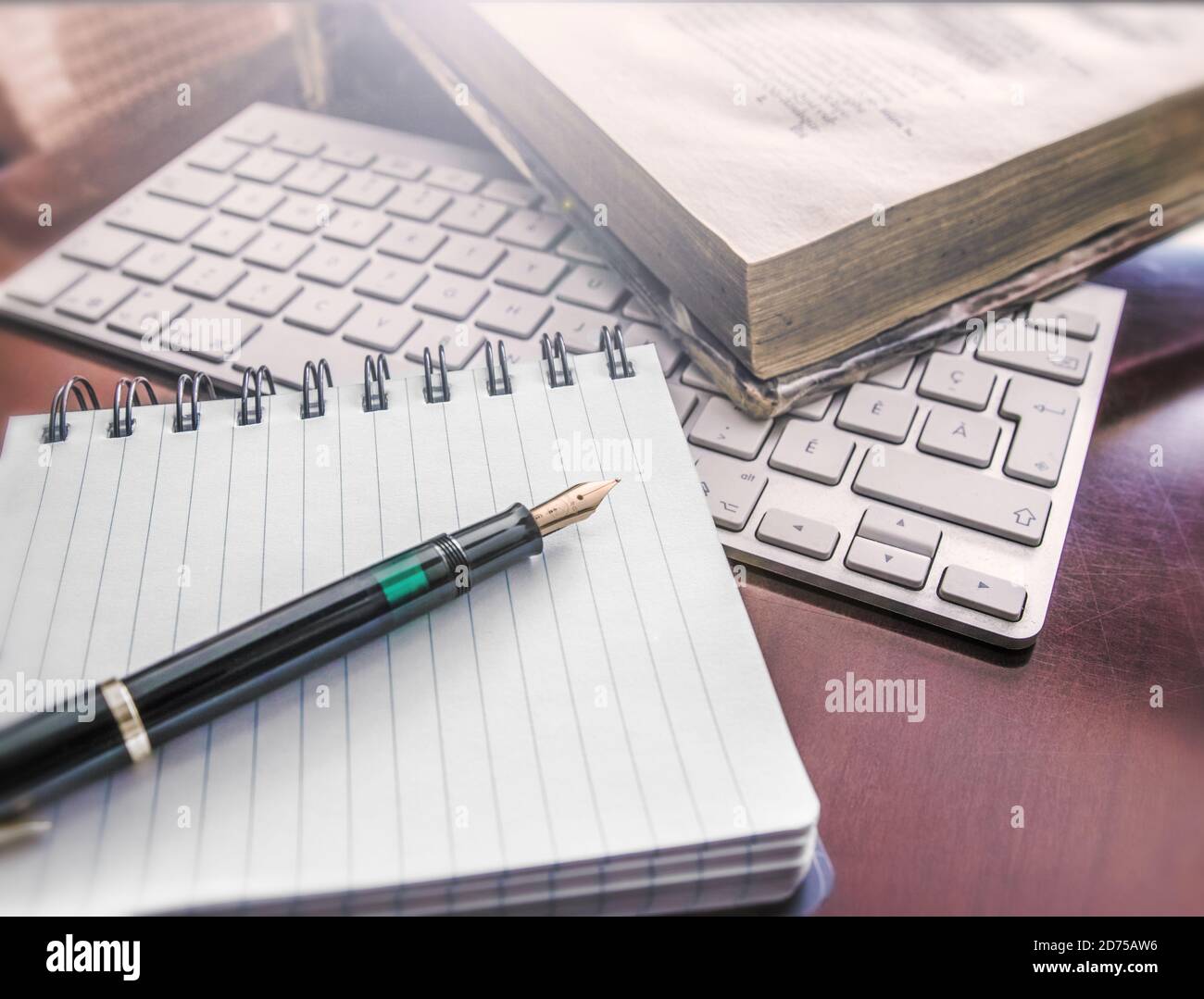 Ancient book, computer k-board, fountain pen and notes book Stock Photo ...
