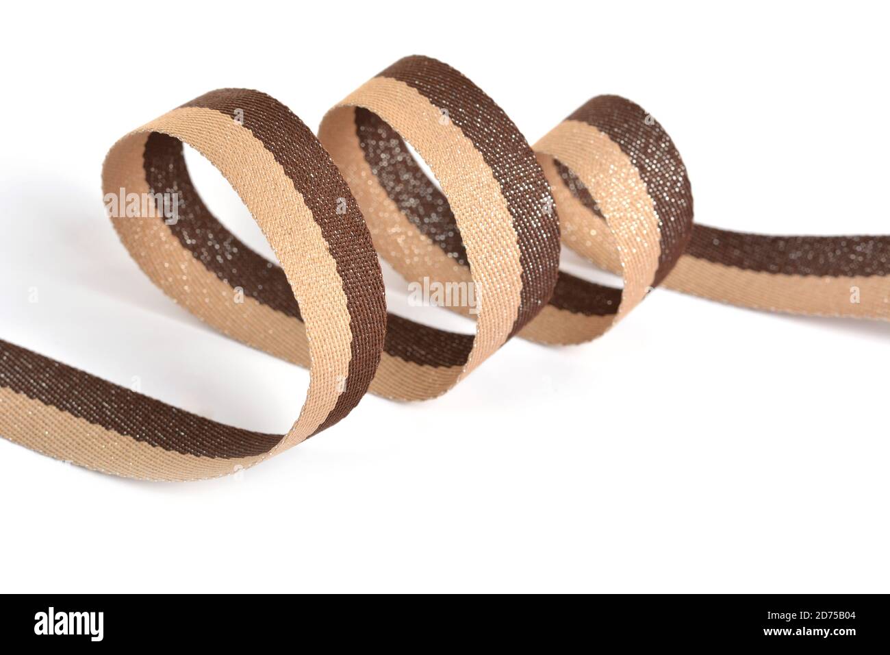 Brown beige Cotton ribbon, strapping tape with curl on white backgroud. Use for sewing clothes, bags. Space for text. Stock Photo