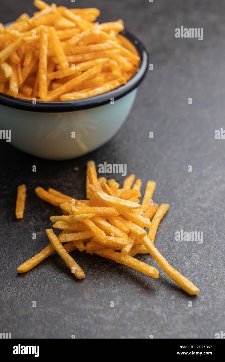 French fries. Fried mini potato sticks on black table Stock Photo Alamy