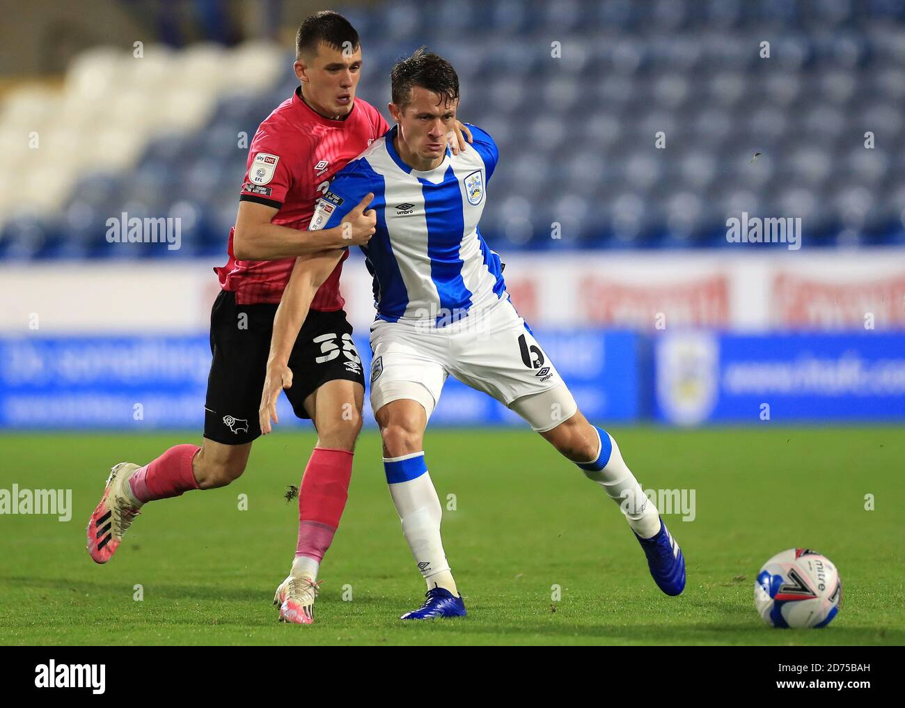 Derby County's Jason Knight (left) and Huddersfield Town's Jonathan Hogg battle for the ball during the Sky Bet Championship match at The John Smith's Stadium, Huddersfield. Stock Photo