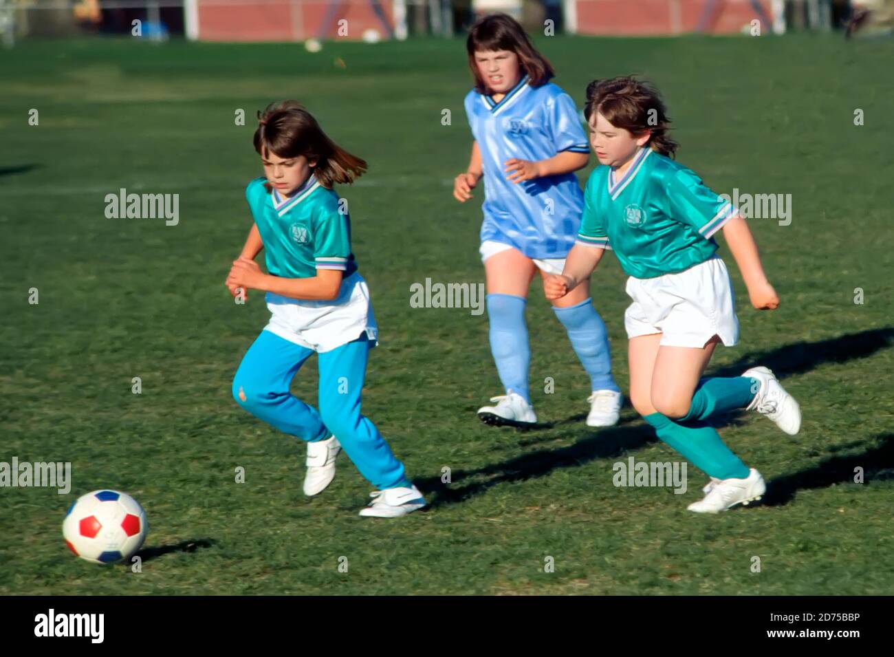 Girls 9 to 11 years old play organized soccer or football Stock Photo