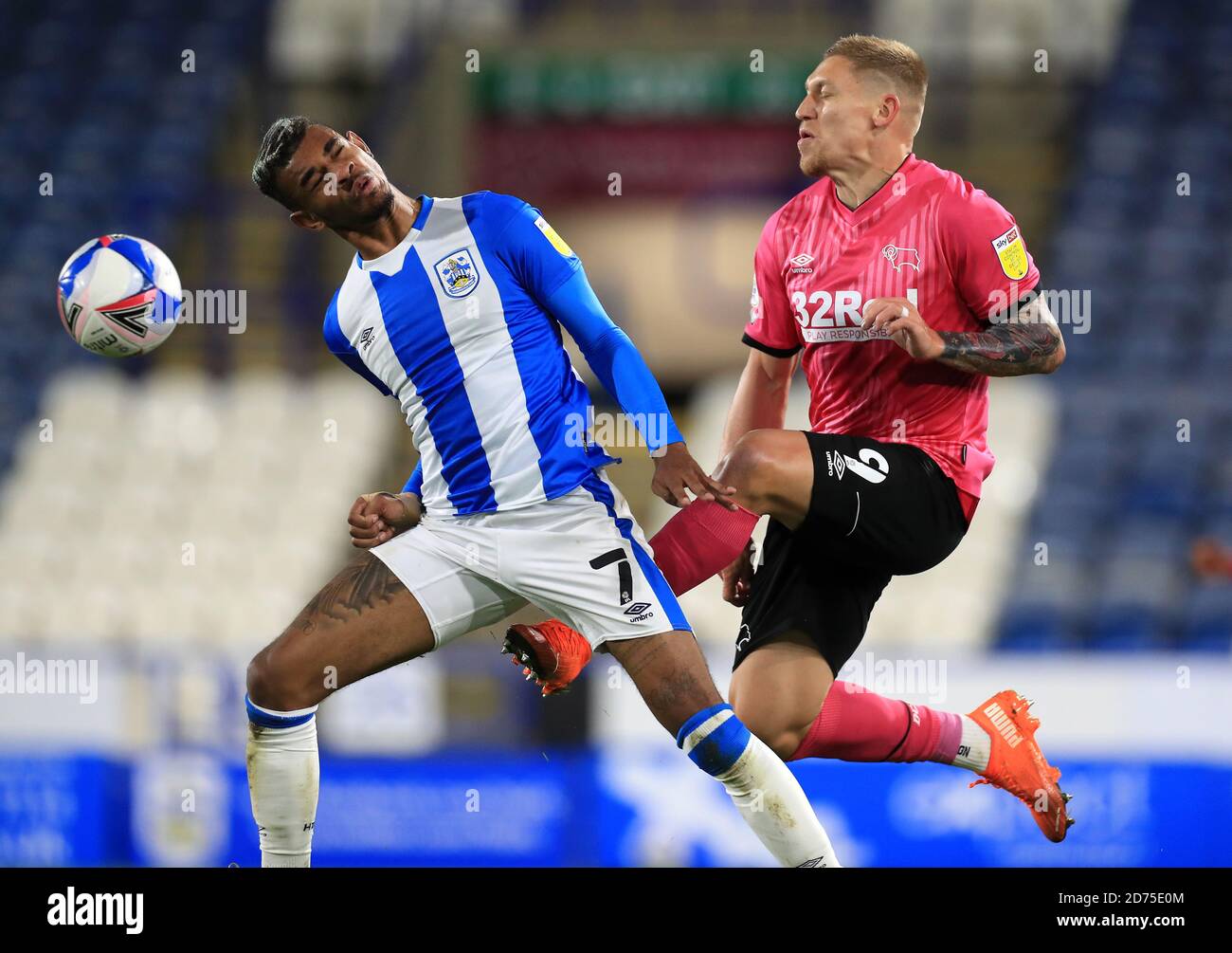 Derby County's Martyn Waghorn (right) and Huddersfield Town's Juninho Bacuna battle for the ball during the Sky Bet Championship match at The John Smith's Stadium, Huddersfield. Stock Photo