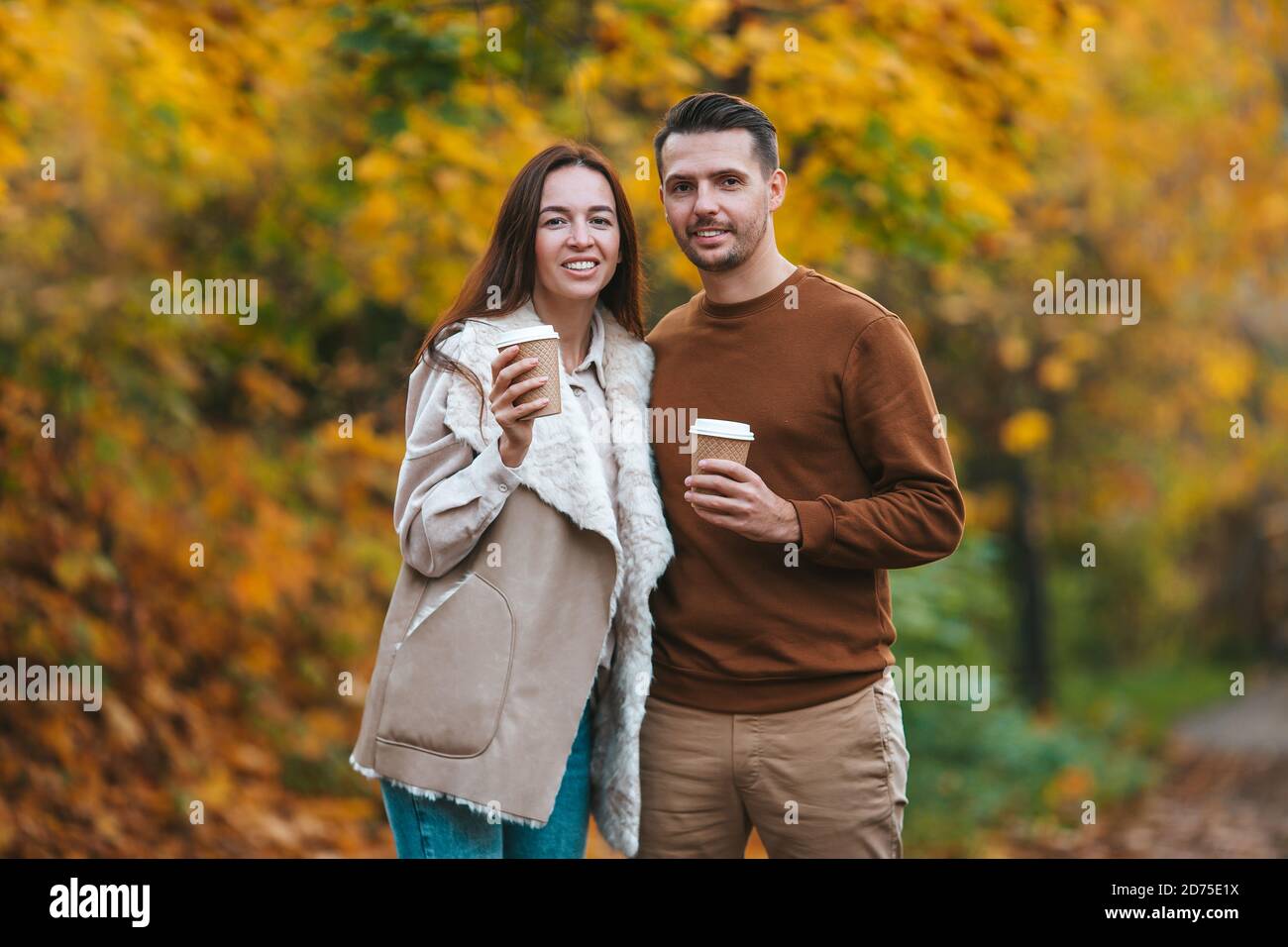 Happy family walking in autumn park on sunny fall day Stock Photo - Alamy
