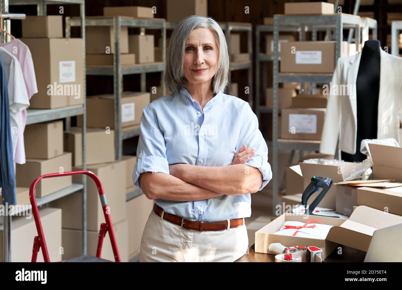 Female entrepreneur clothing store business owner in warehouse, portrait. Stock Photo