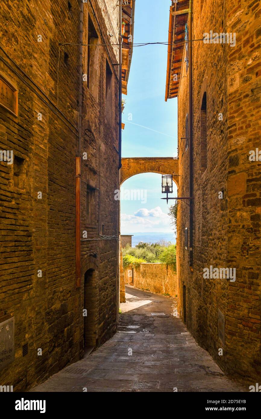 Glimpse of a narrow alley in the historic centre of the medieval town of San Gimignano, Unesco World Heritage Site, Siena, Tuscany, Italy Stock Photo