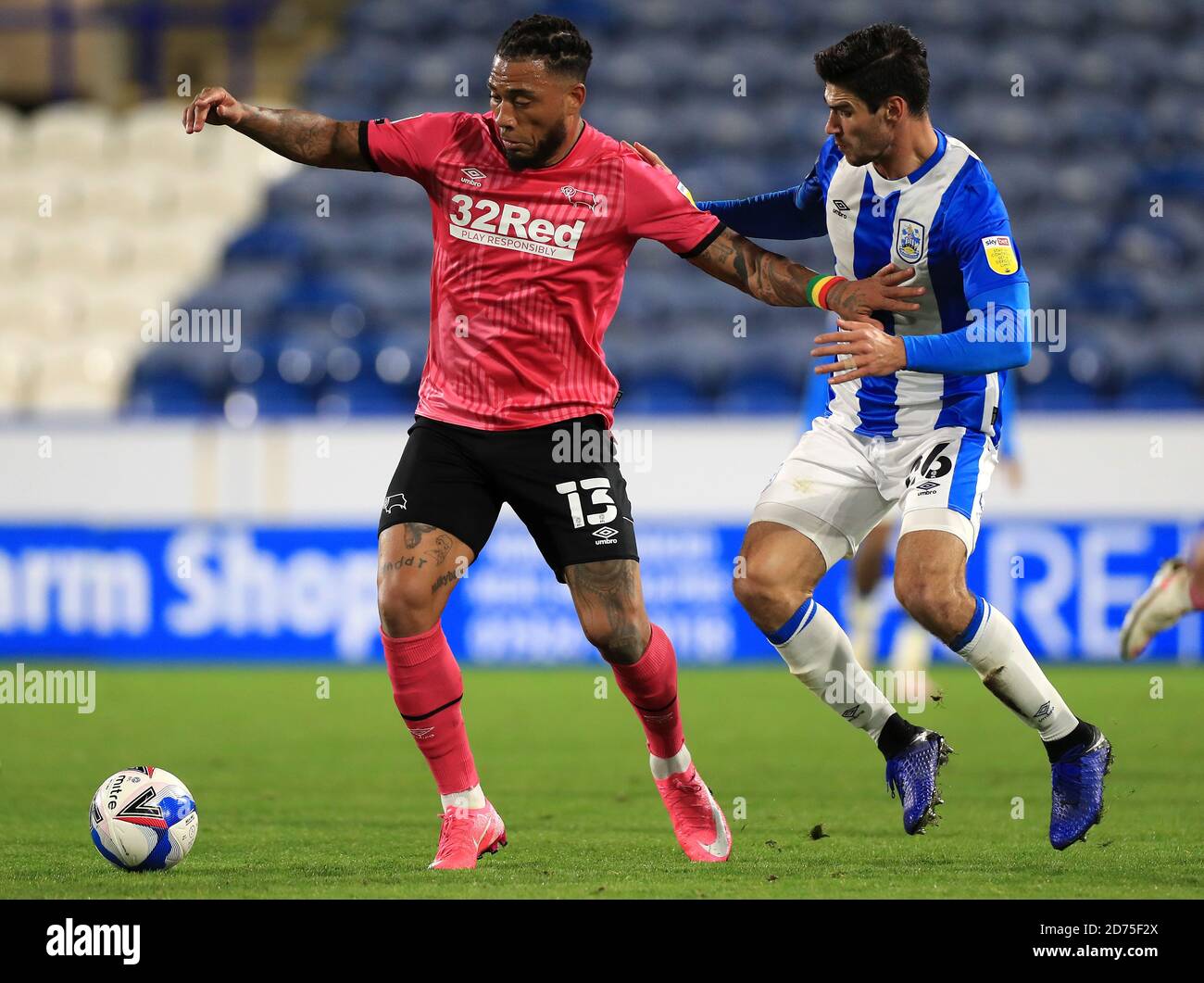 Derby County's Colin Kazim-Richards (left) and Huddersfield Town's Christopher Schindler battle for the ball during the Sky Bet Championship match at The John Smith's Stadium, Huddersfield. Stock Photo