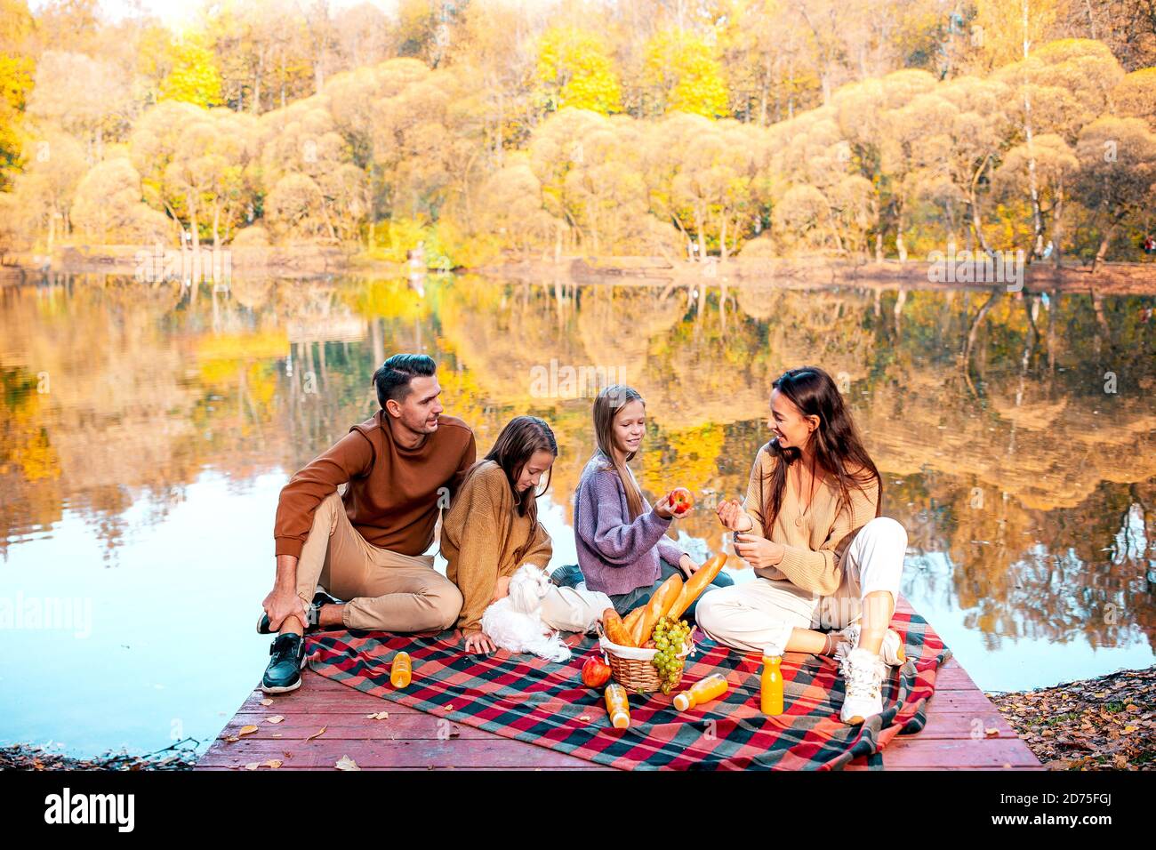 Happy family on a picnic in the park at autumn Stock Photo - Alamy