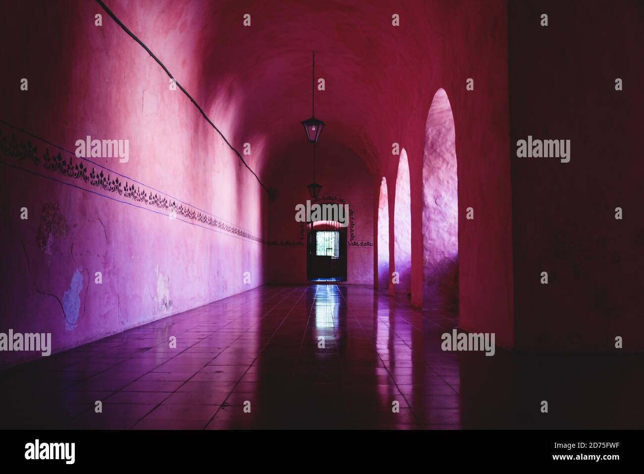 Pink orange colored corridor of the former monestary Convent de San Bernardino de Siena in Valladolid, Yucatan, Mexico Stock Photo