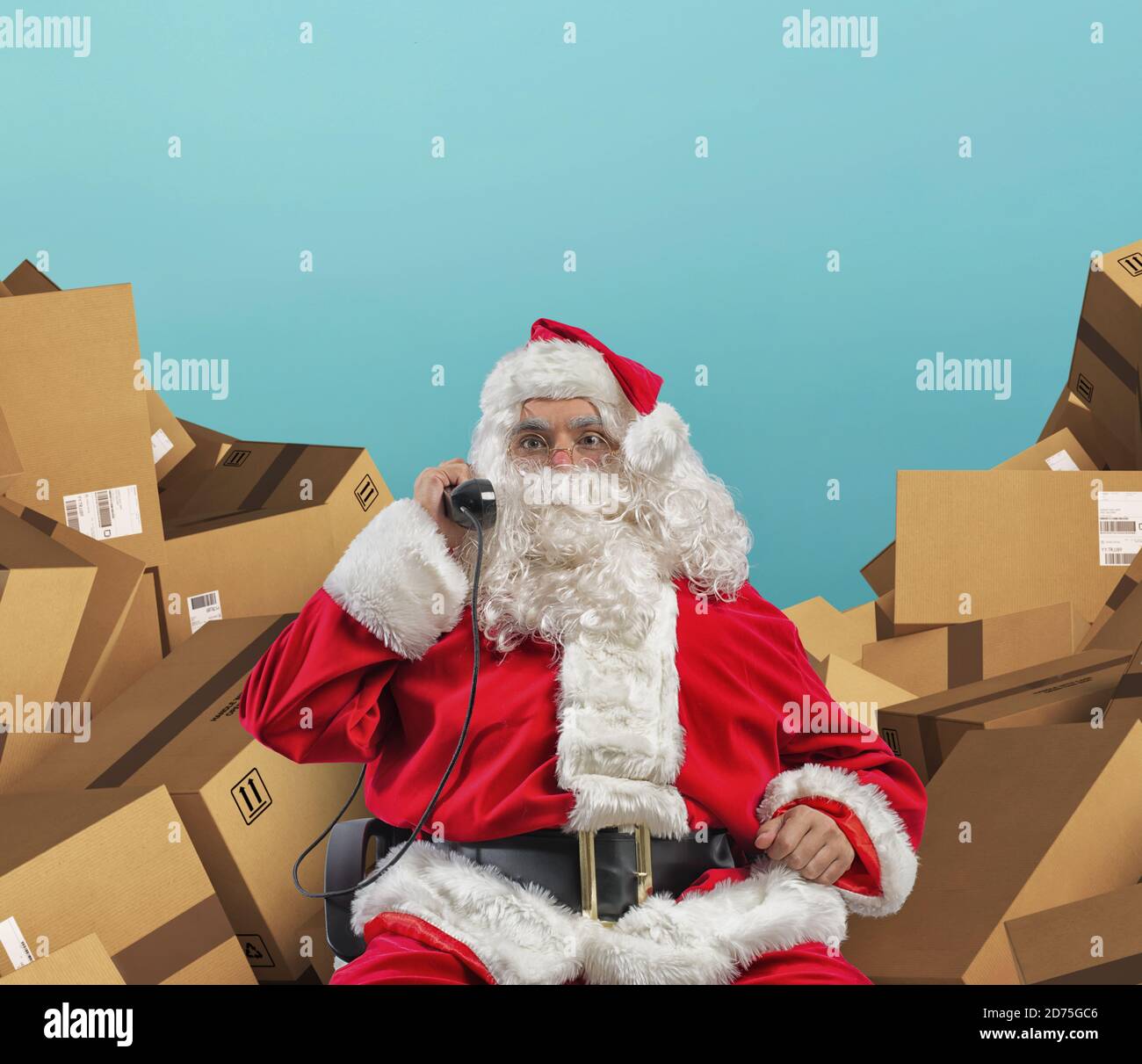 Santa Claus receives telephone calls for presents request Stock Photo