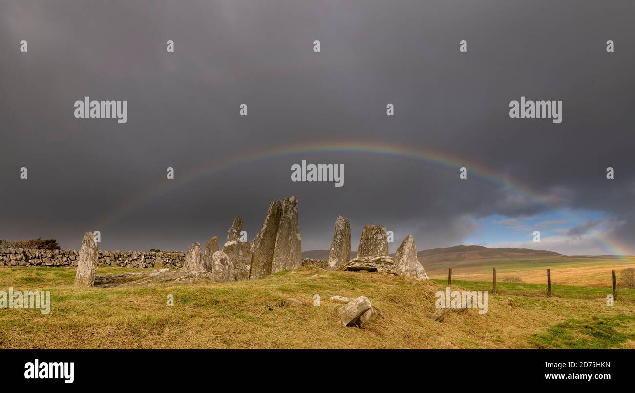 Cairn Holy 1 set against a dark sky and rainbow Stock Photo