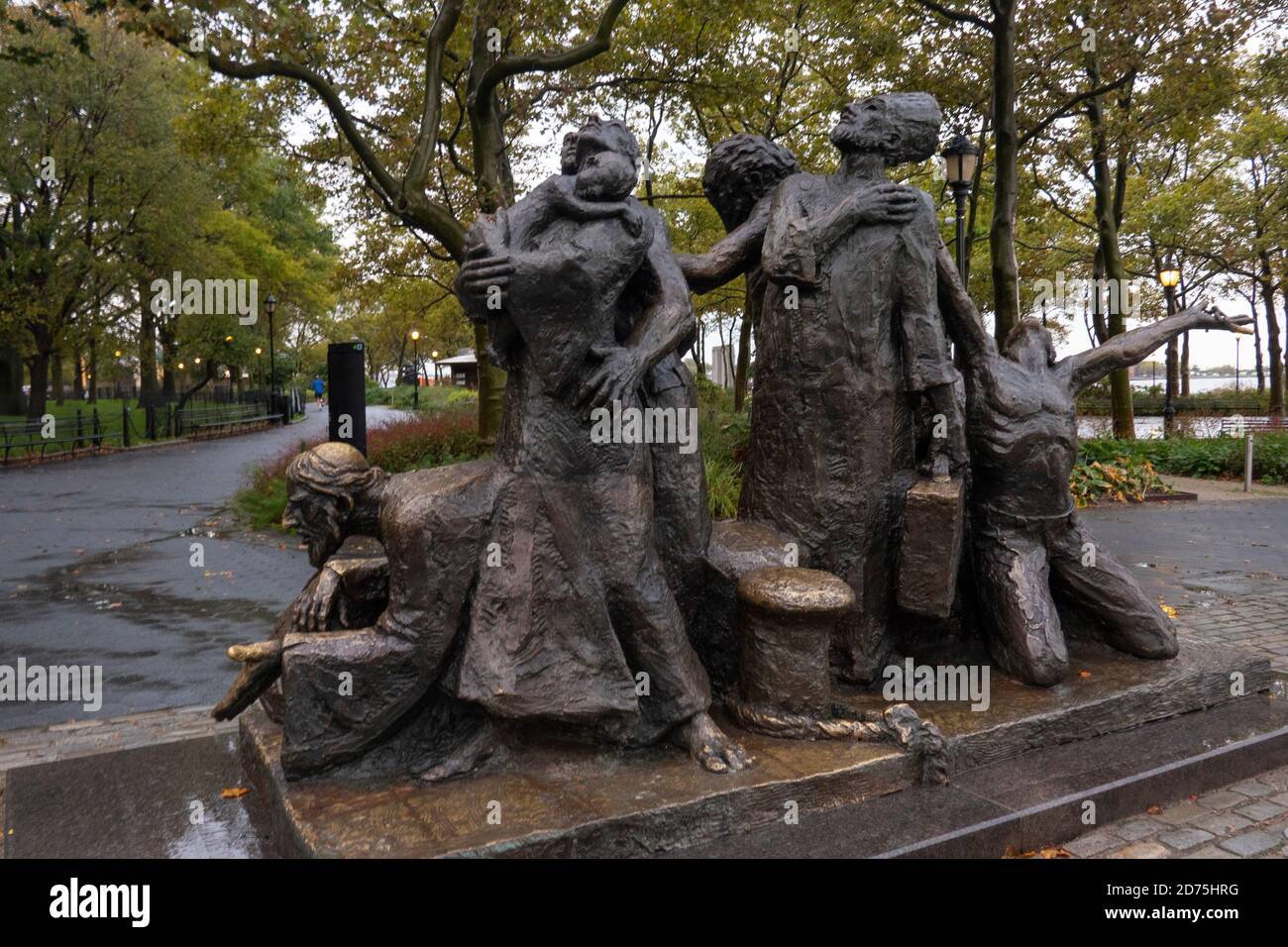 The Immigrants statue in Battery Park Manhattan NYC Stock Photo