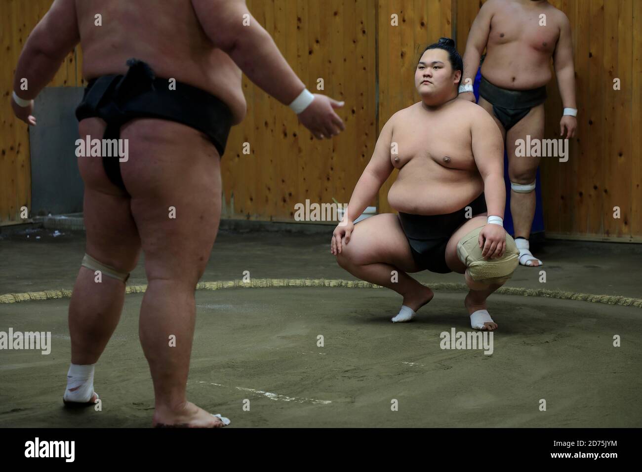 Japanese Sumo wrestlers training inside a traditional Sumo stable in early morning.Koto City.Tokyo.Japan Stock Photo