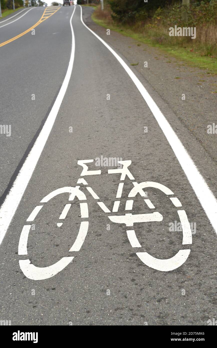 A bicycle logo designates an uphill bike lane on Vancouver Island, British Columbia, Canada Stock Photo