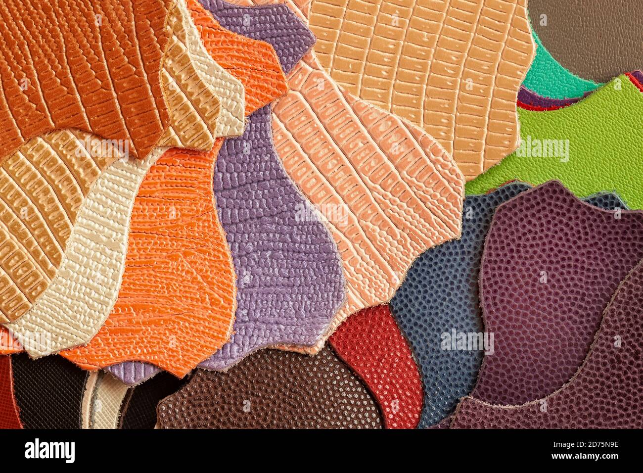 Variety of leather samples of different textures and colors, top view, manufacturing of fashion