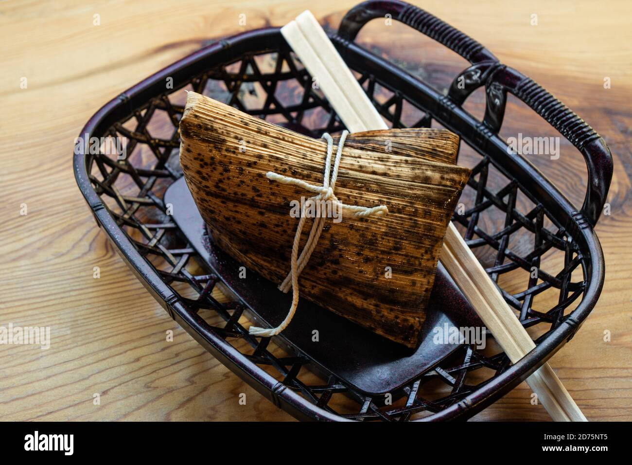 Steamed rice dumpling wrapped in bamboo leaves Stock Photo