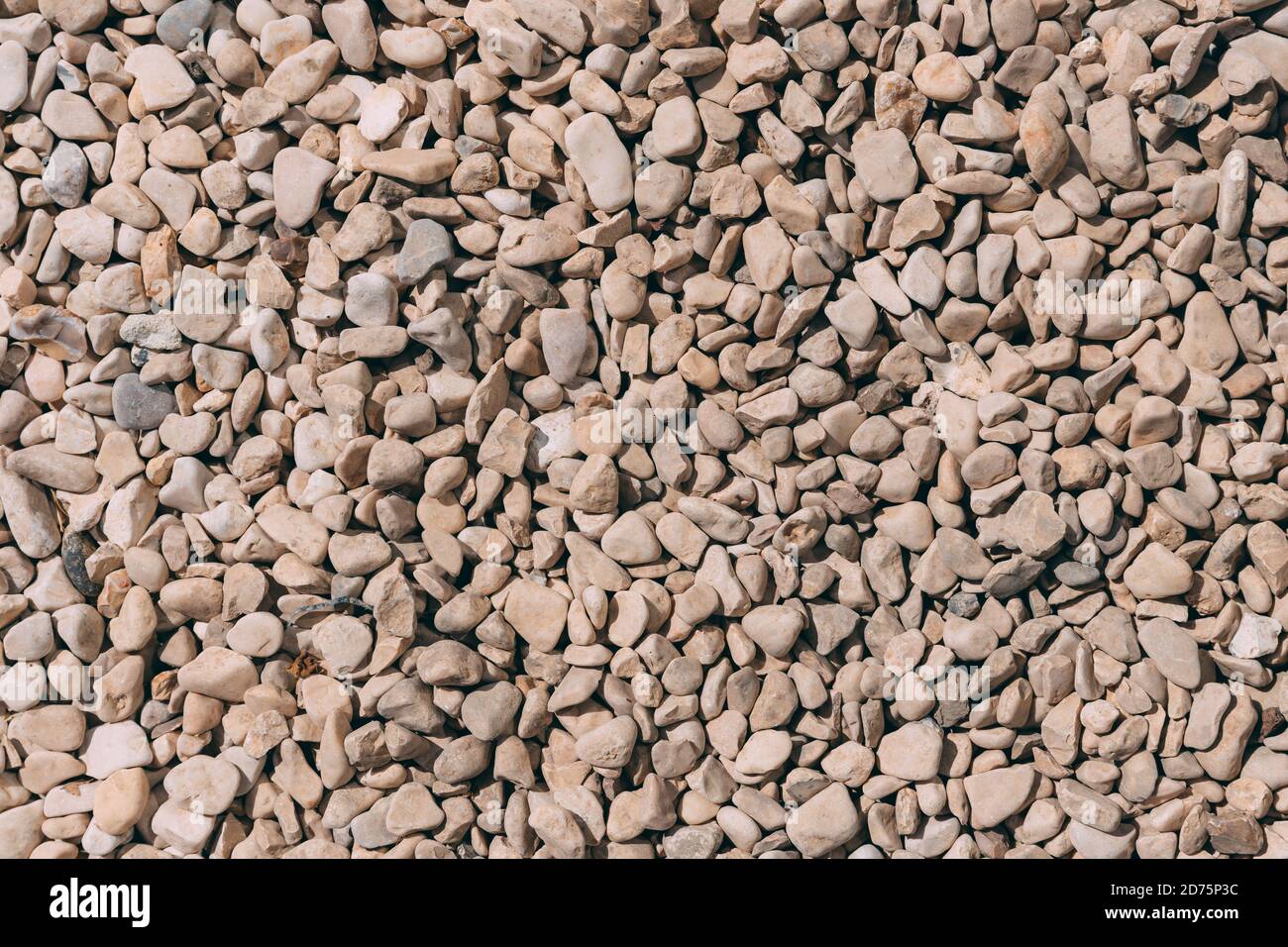 Small Beie Rocks Top view of beidge pebbles stone texture and background. Colorful small ...