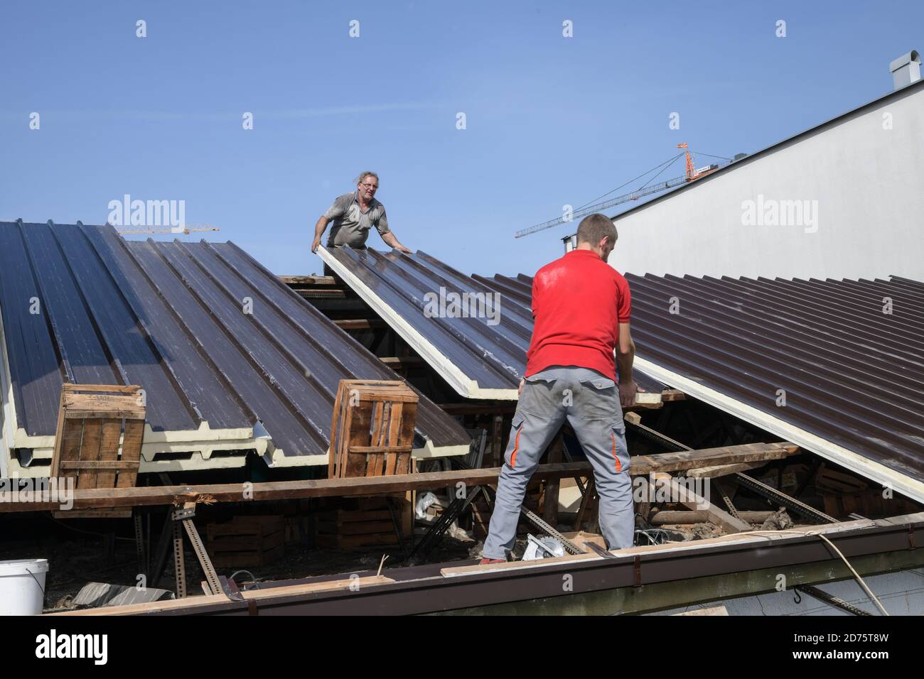 Two workers roofer builder working on roof structure on construction site Stock Photo