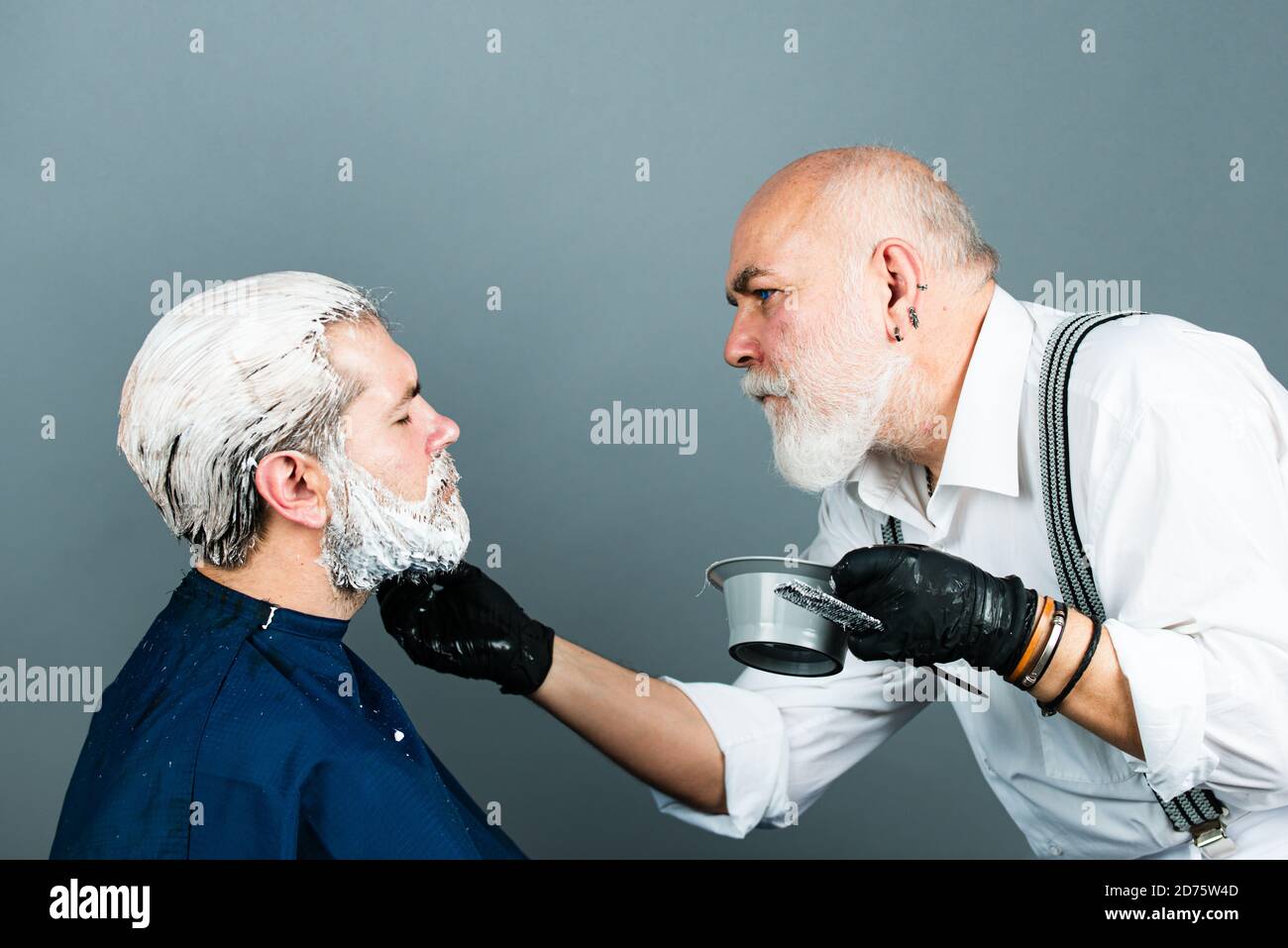 Barber coloring hair handsome man. Beard color Stock Photo - Alamy