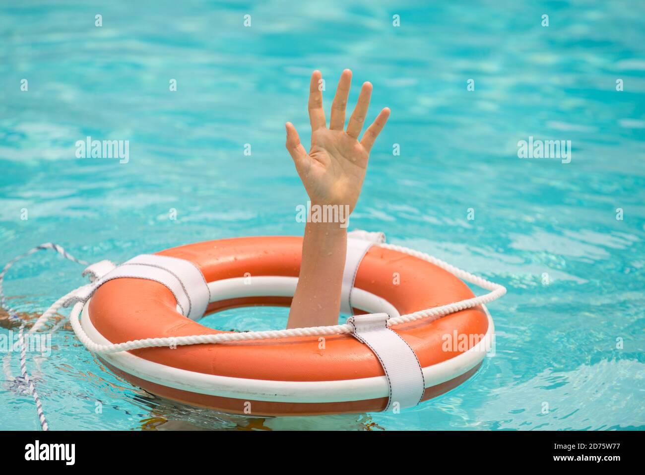 Lifebuoy with hands in the water. Life buoy and helping to survive. Support survival or save. Stock Photo