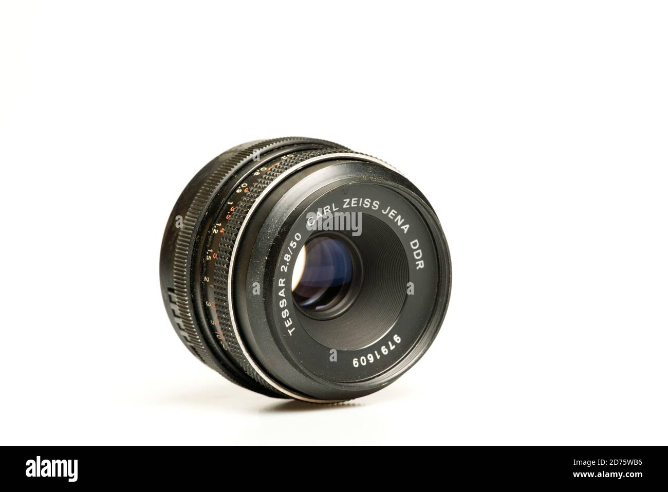 Carl Zeiss Jena DDR 50mm f2.8 Tessar lens laying on white table Stock Photo