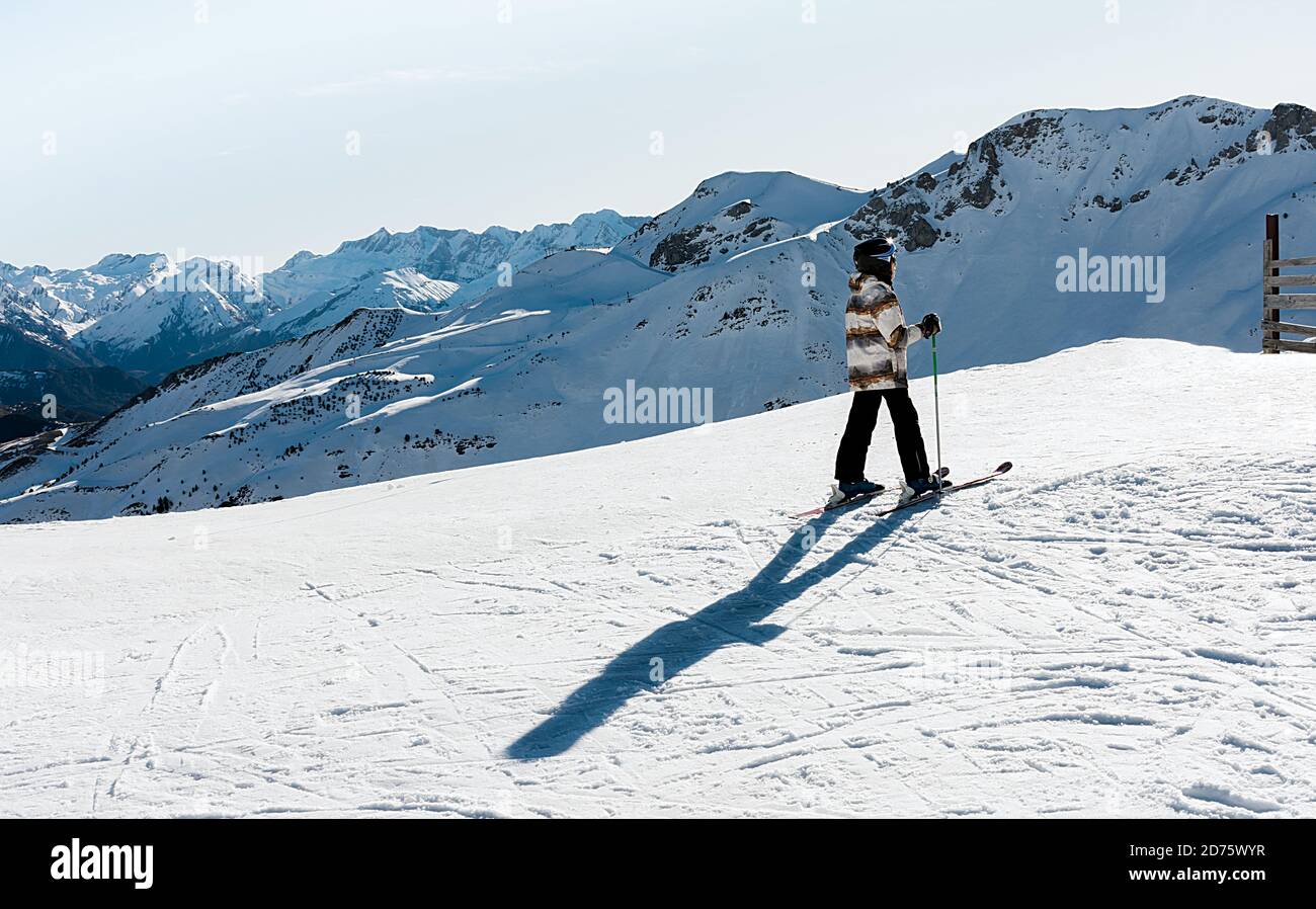 a boy skiing on the white snow of Formigal with Pyrenees mountains on background. Horizontal photo Stock Photo