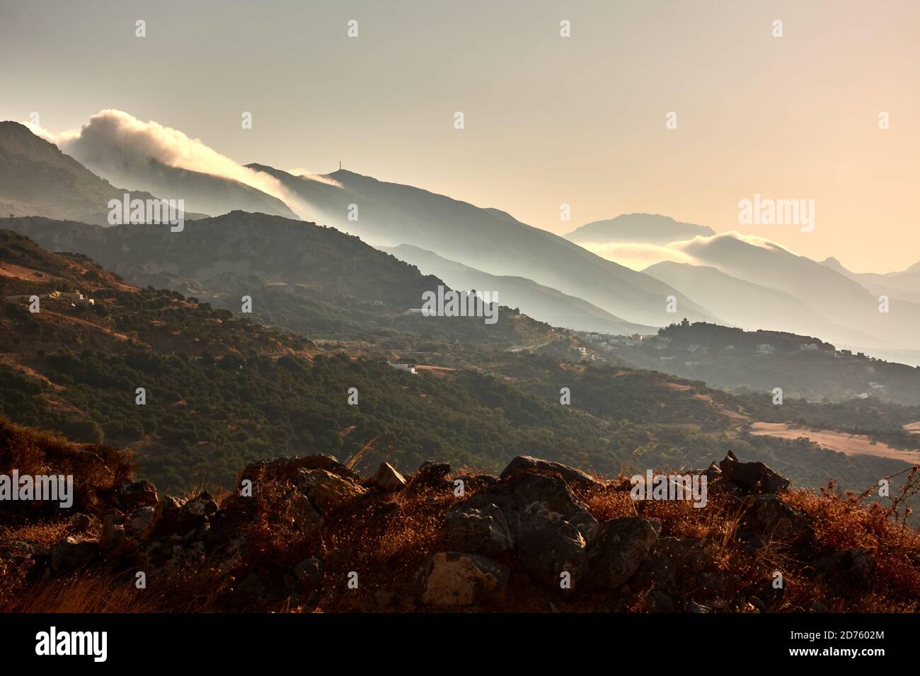 Scenic mountainscape at sunset, a panoramic shot of green woodland Stock Photo