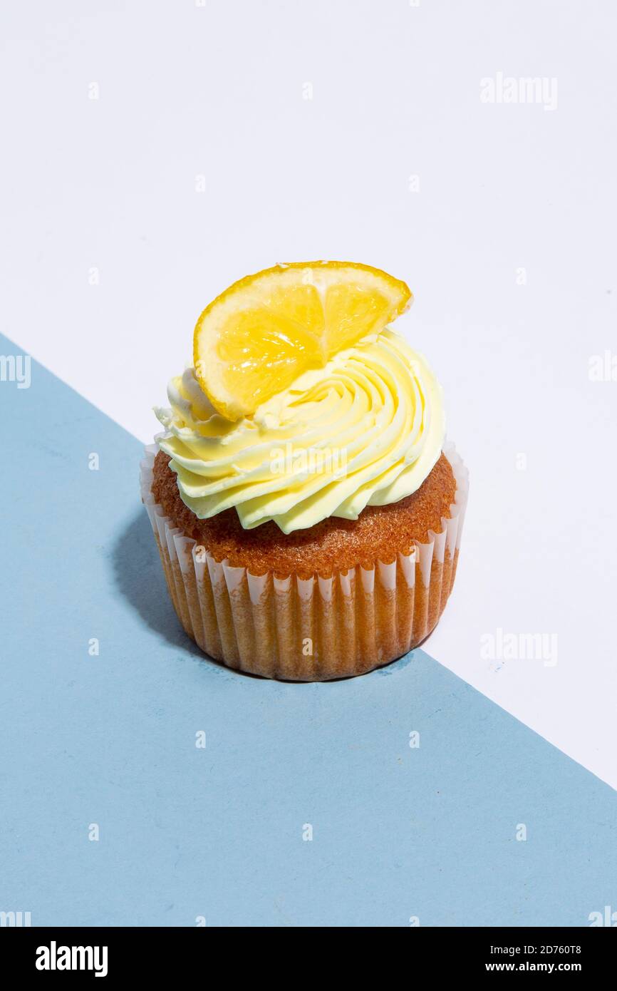 Lemon Cupcake on Blue and White Background Stock Photo