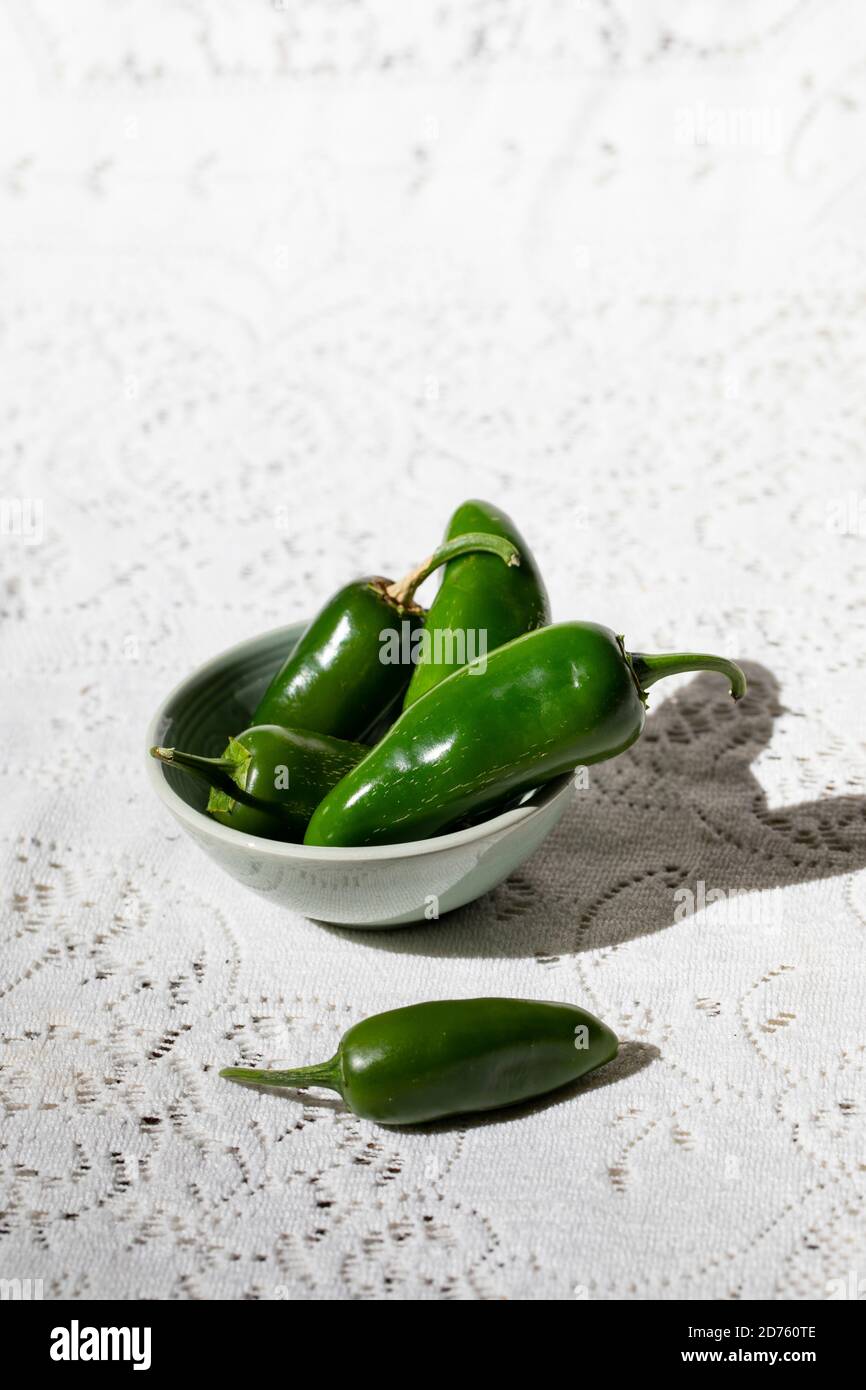 Jalapeno Peppers in White Bowl on White Background Stock Photo