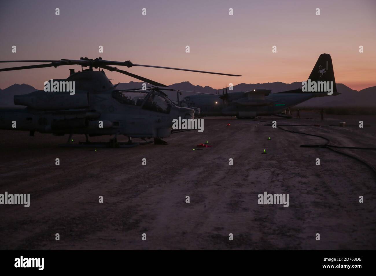 U.S. Marine Corps AH-1Z Vipers and a KC-130J Hercules assigned to Marine Aviation Weapons and Tactics Squadron One (MAWTS-1), perform an air delivered ground refueling during Weapons and Tactics Instructor (WTI) course 1-21, at Stoval Airfield, Dateland, Arizona, Oct. 16, 2020. The WTI course is a seven-week training event hosted by MAWTS-1, providing standardized advanced tactical training and certification of unit instructor qualifications to support Marine aviation training and readiness and assists in developing and employing aviation weapons and tactics. (U.S. Marine Corps photo by Sgt. A Stock Photo