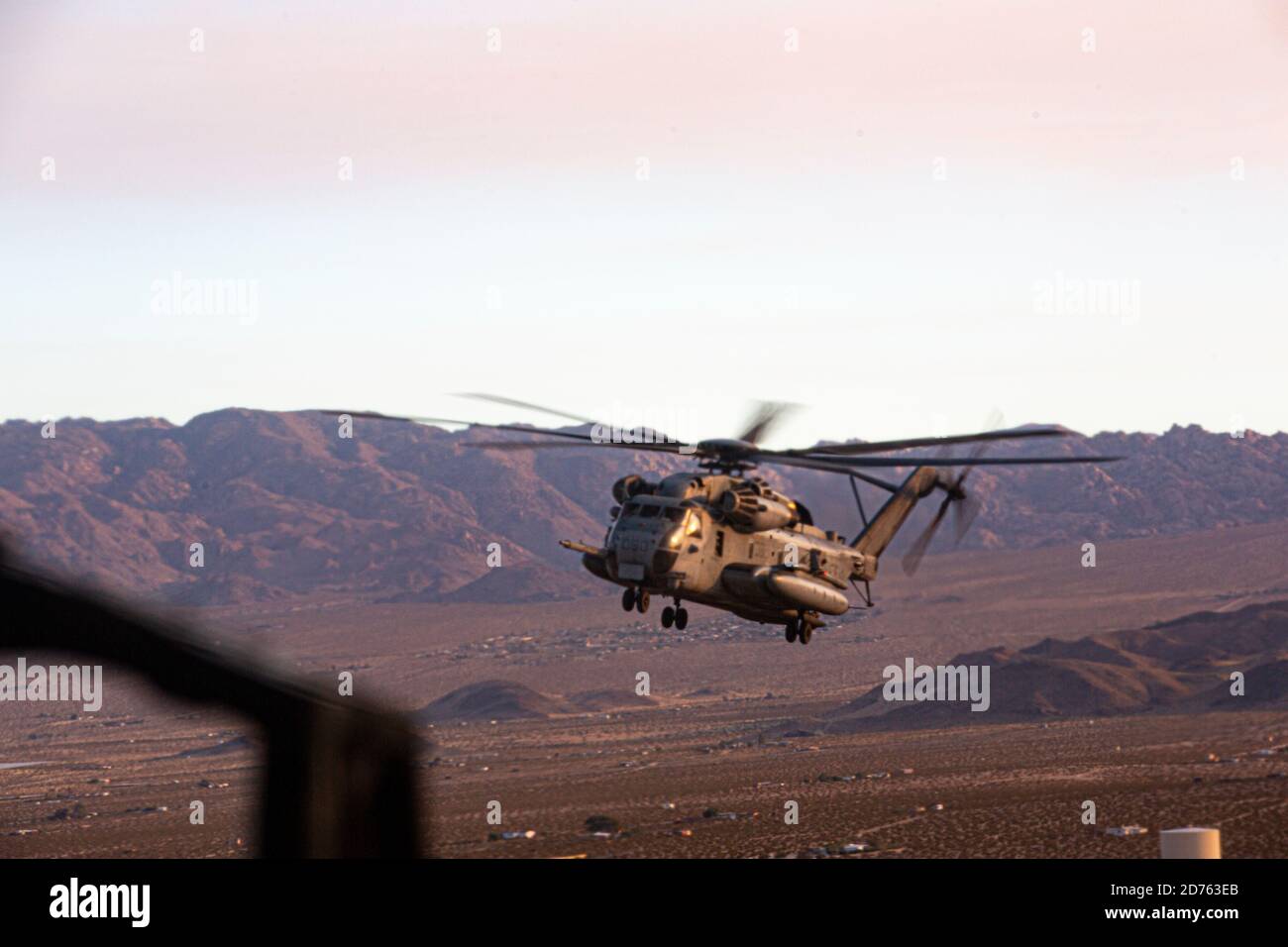 A U.S. Marine Corps CH-53 Super Stallion assigned to Marine Aviation Weapons and Tactics Squadron One (MAWTS-1), participating in Weapons and Tactics Instructor (WTI) course 1-21, flies over Twentynine Palms, California, Oct. 16, 2020. The WTI course is a seven-week training event hosted by MAWTS-1, providing standardized advanced tactical training and certification of unit instructor qualifications to support Marine aviation training and readiness, and assists in developing and employing aviation weapons and tactics. (U.S. Marine Corps photo by Cpl. Juan Dominguez) Stock Photo