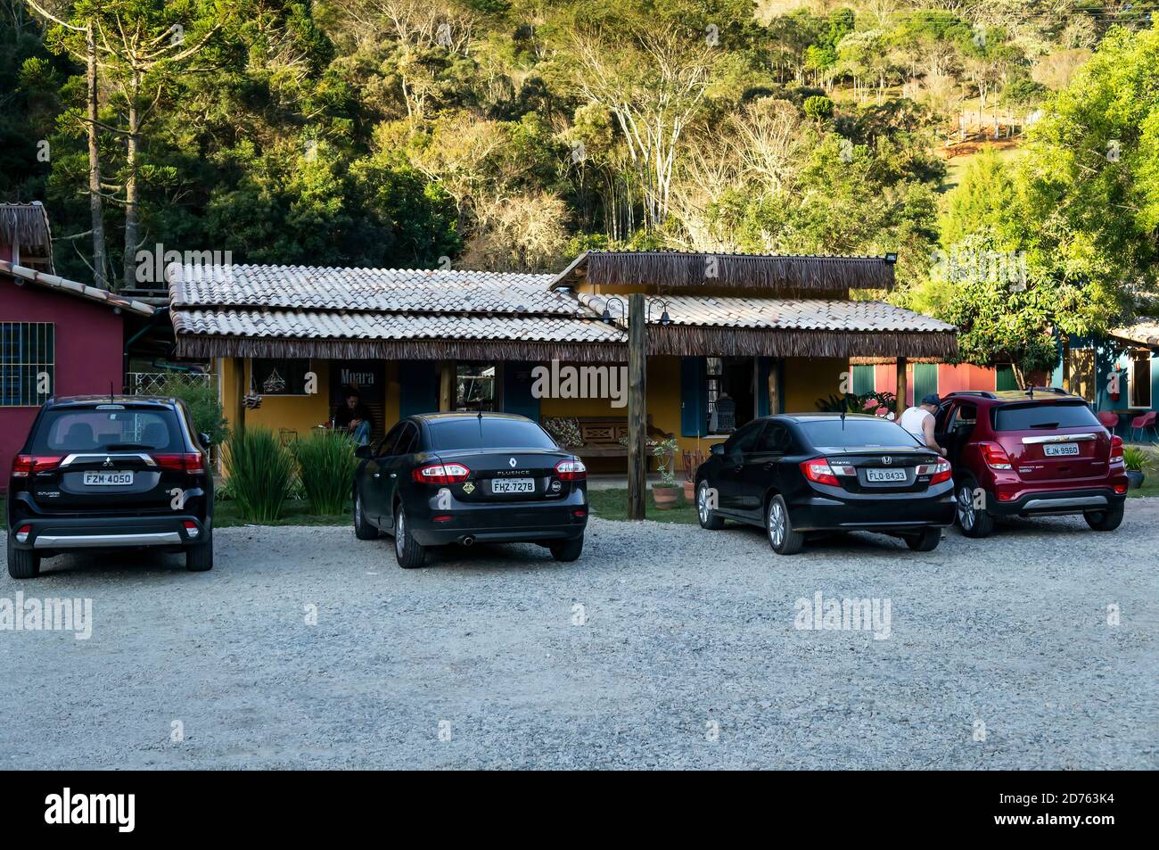 Cars parked on the parking spaces at Moara Cafe, a well known coffee shop and restaurant located by Salvador Pacetti road in Cunha countryside. Stock Photo