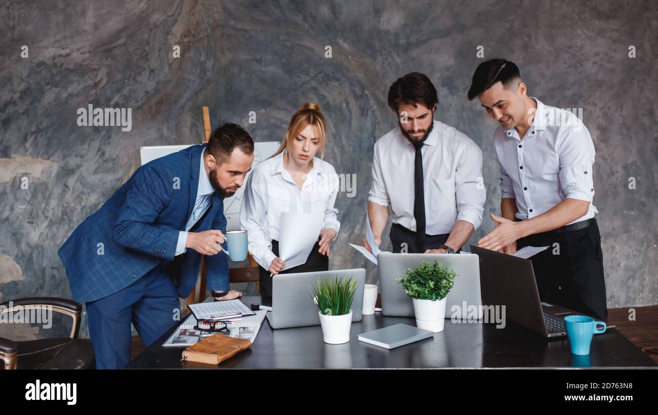 The business team looks at the laptop screen. the concept of waiting for the result of a business transaction. business partners are looking forward Stock Photo