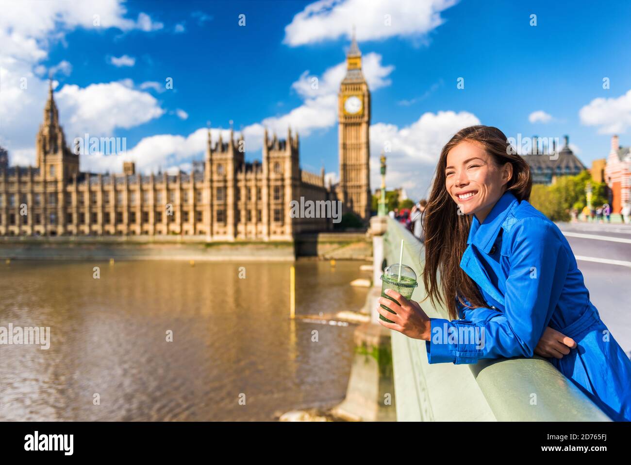 London Big Ben tourist woman drinking green detox smoothie. Healthy businesswoman on Westminster Bridge with Big Ben background, London Europe Stock Photo