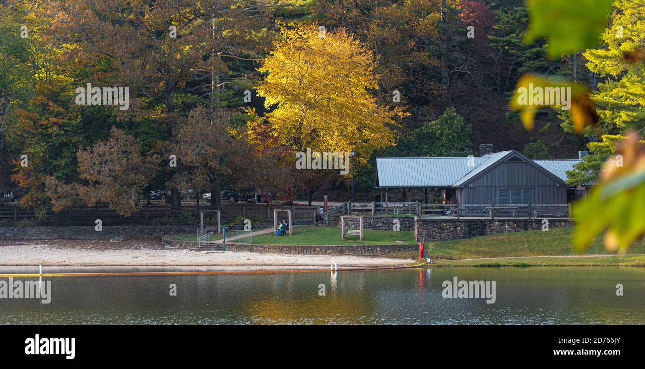 Father and sons relaxing on a bench swing at Lake Trahlyta beach in