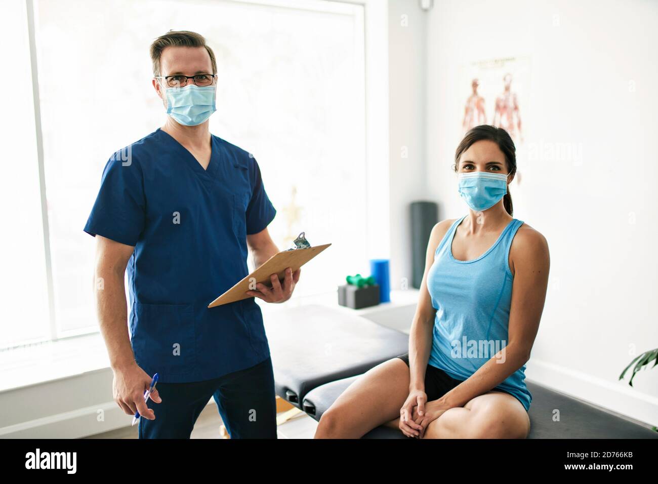 Male Physical Therapist Stretching A Female Patient Slowly Stock Photo ...