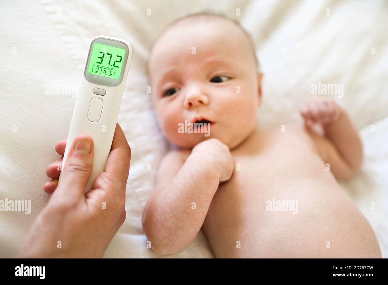 Temperature of healthy baby lay on the bedroom Stock Photo Alamy