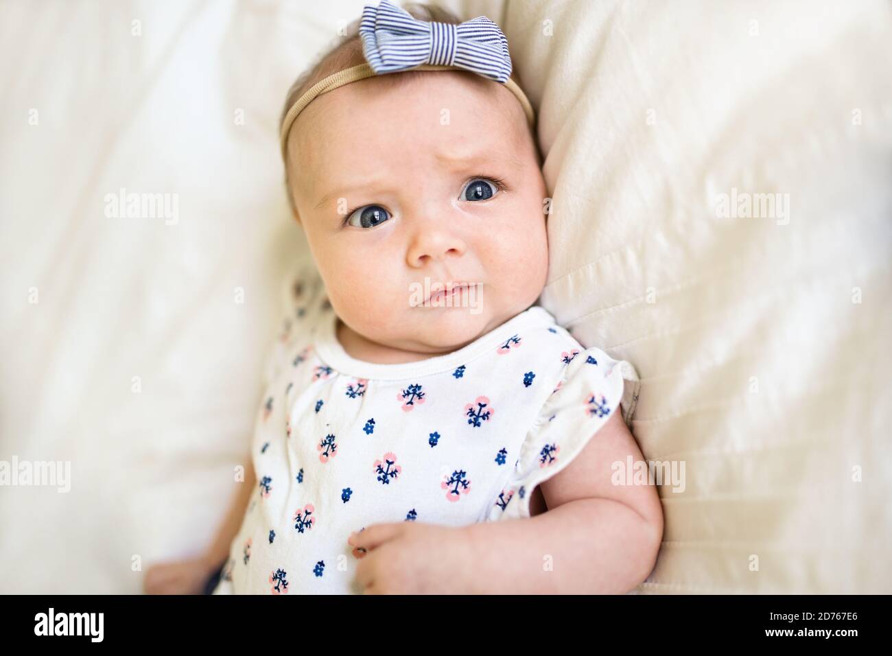 happy newborn baby on the bed wearing cute clothes Stock Photo Alamy