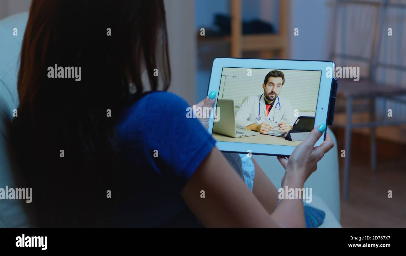 Remote patient using tablet having video conference with doctor. Stock Photo