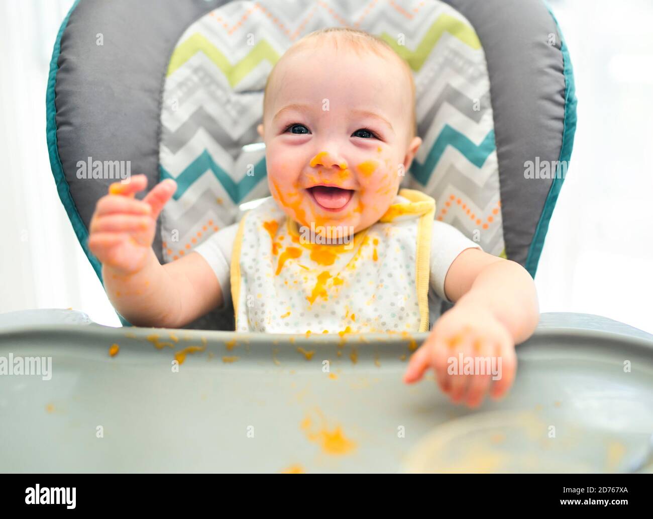 happy little cute baby girl with mash food everywhere Stock Photo Alamy