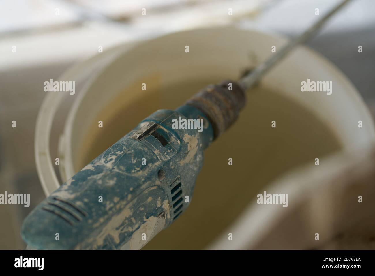 Drill mixer stirring mortar repair construction tools Stock Photo Alamy