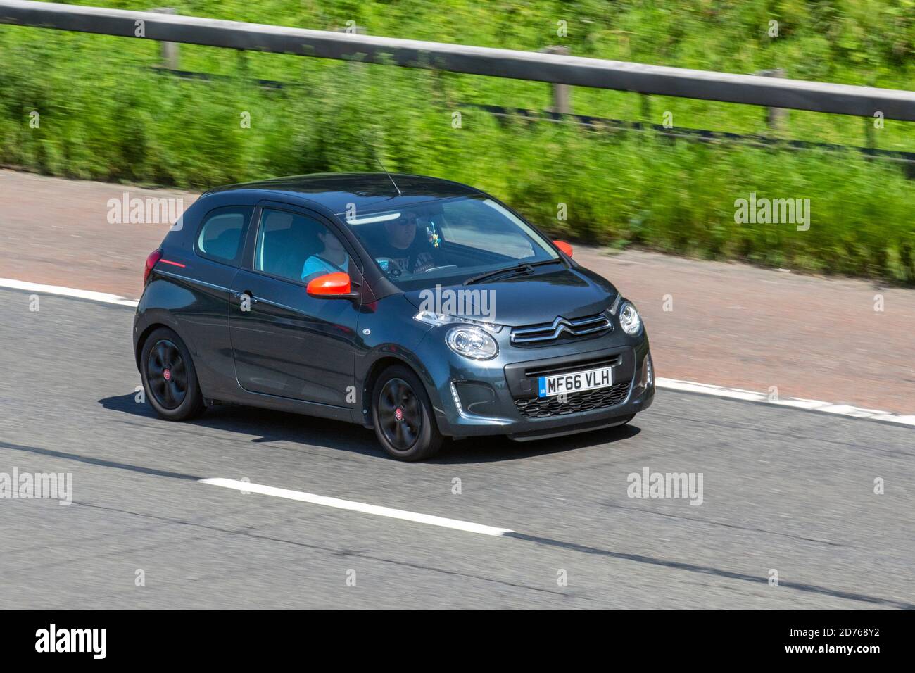 2016 blue Citroën C1 Furio VTI; Vehicular traffic, moving vehicles, cars, vehicle driving on UK roads, motors, motoring on the M6 motorway highway UK road network. Stock Photo