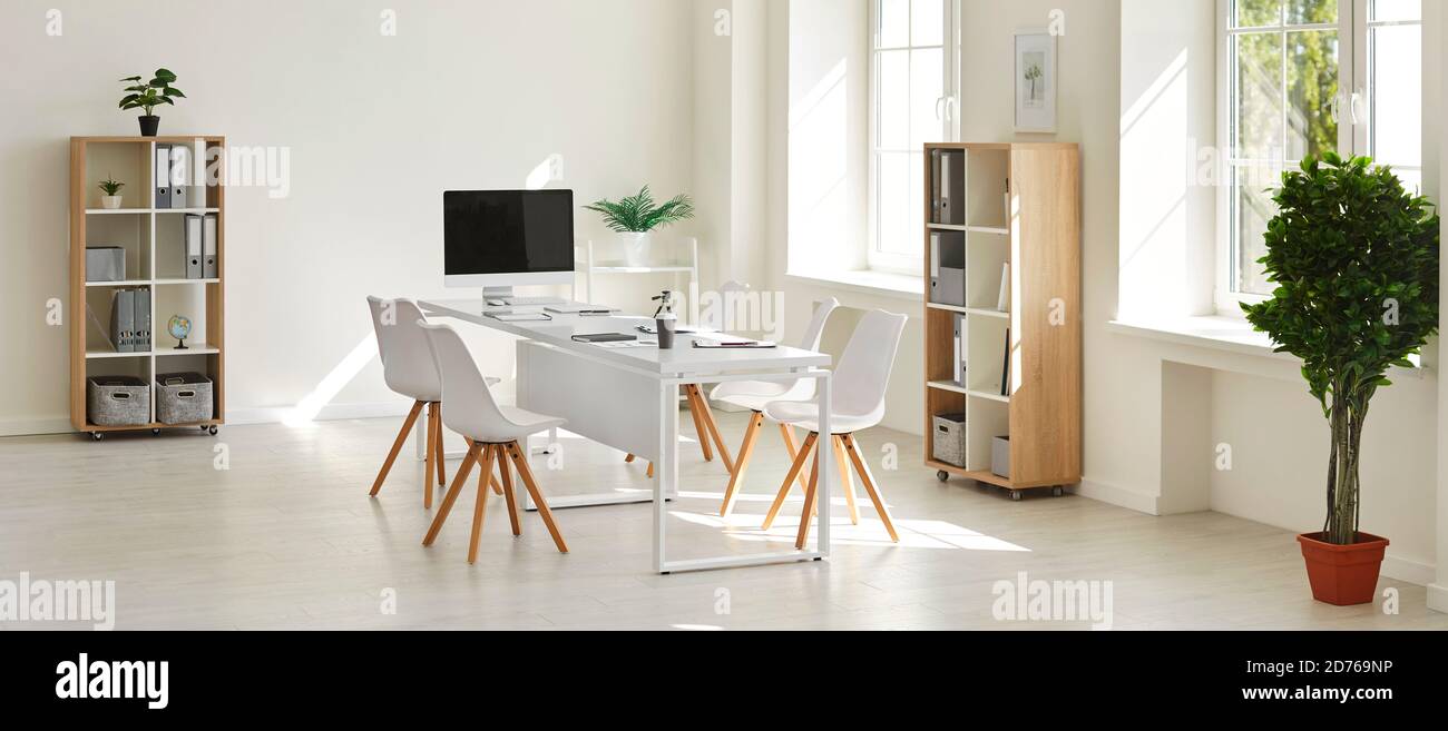 Interior of spacious workspace with table and computer for business ...