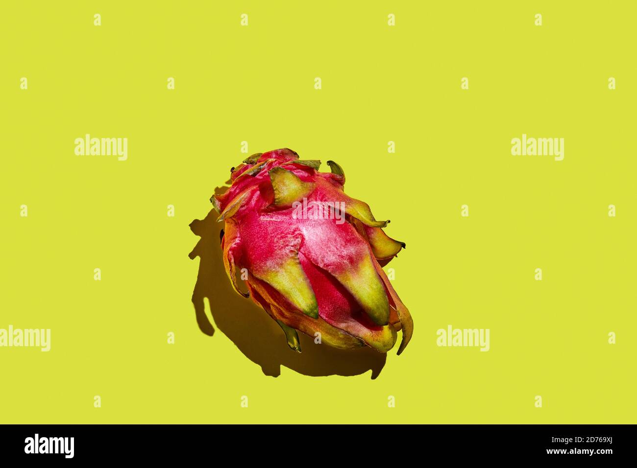 Dragon fruit - whole pitahaya on a yellow background. Stock Photo