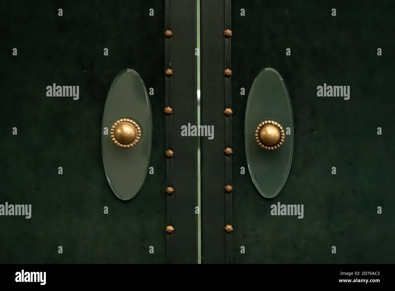 Vintage door handle. Copper door knob on emerald green door Stock Photo