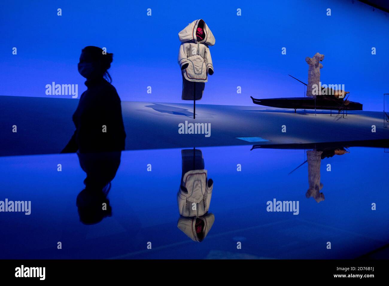 A staff member walks at an Amauti, a parka with a baby carrier built