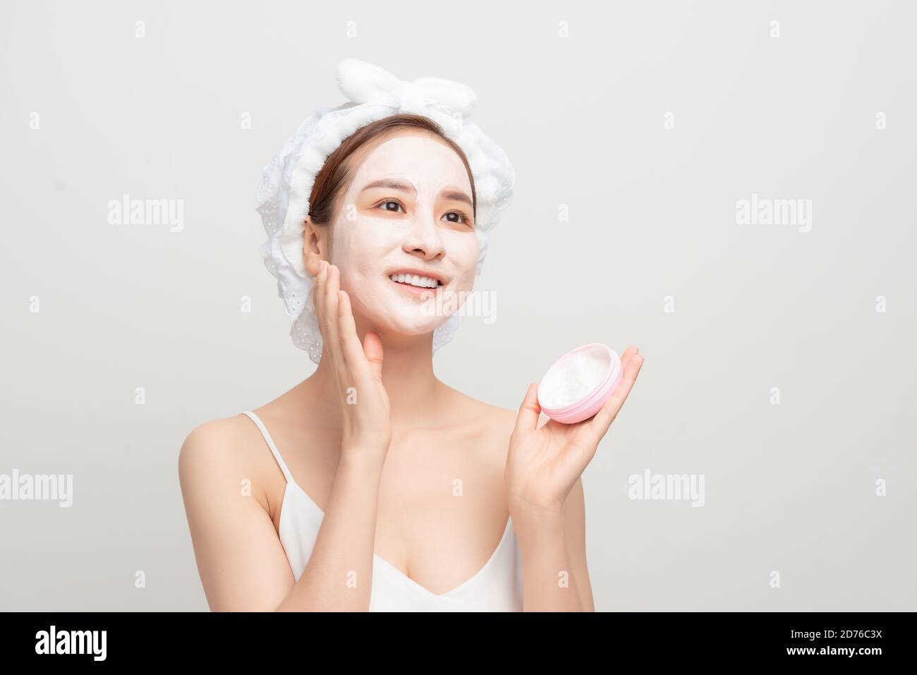 Spa girl applying facial mask. Beauty treatments. Stock Photo