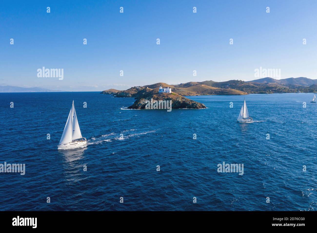 Sailing. Sailboats with white sails, rippled sea background, Lighthouse