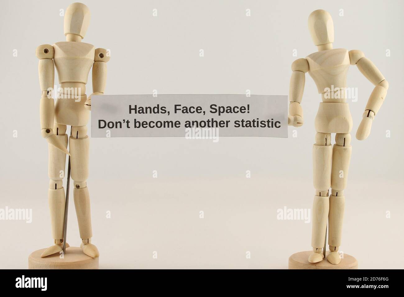 Hands, Face, Space, Don't become another statistic sign held by two Mannequins isolated on a white background Stock Photo