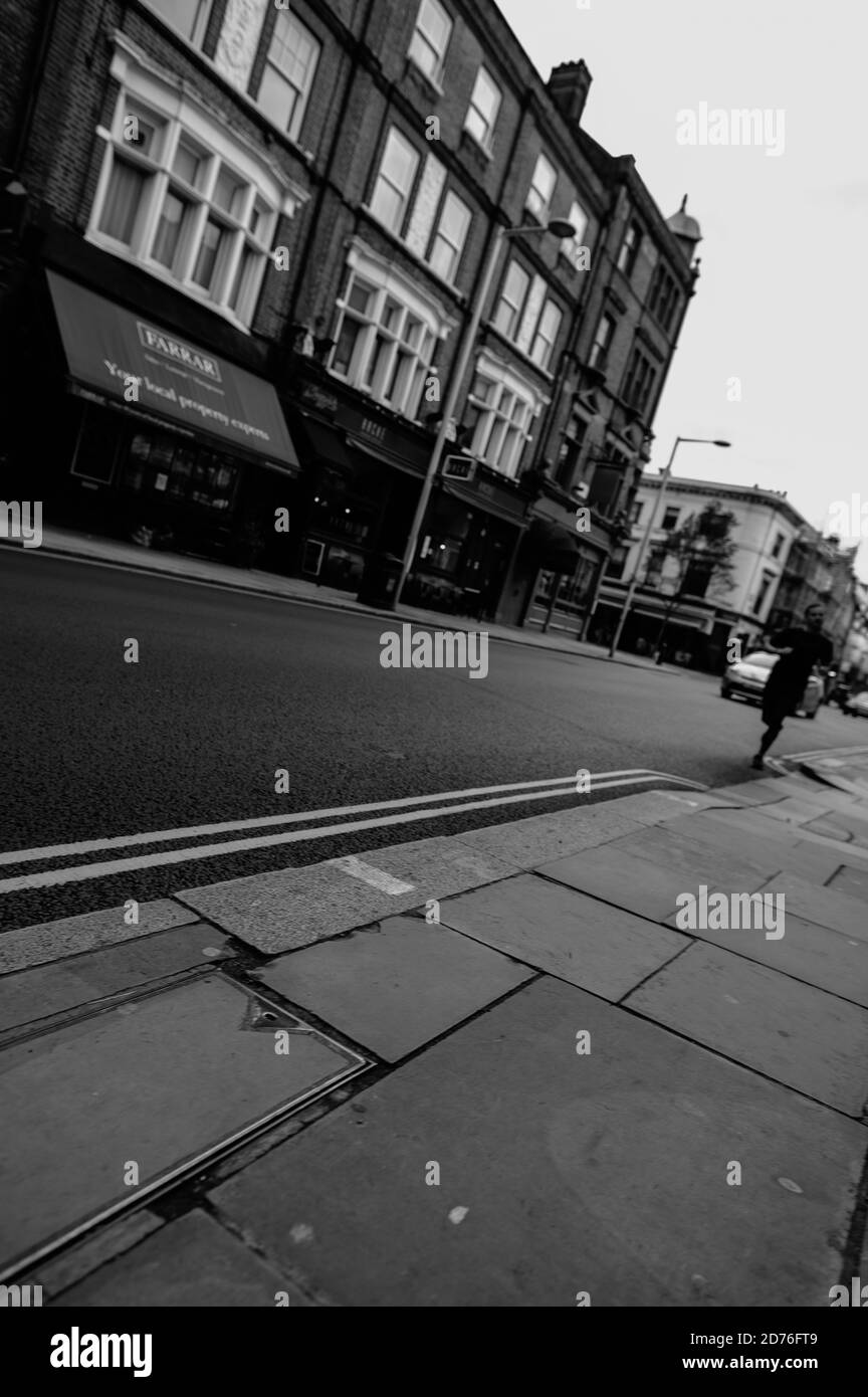 Black and White, monochrome, tilted view of city street with double ...